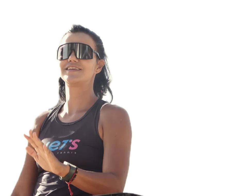 Professora Lidi de óculos esportivos ao lado da caixa de bolas